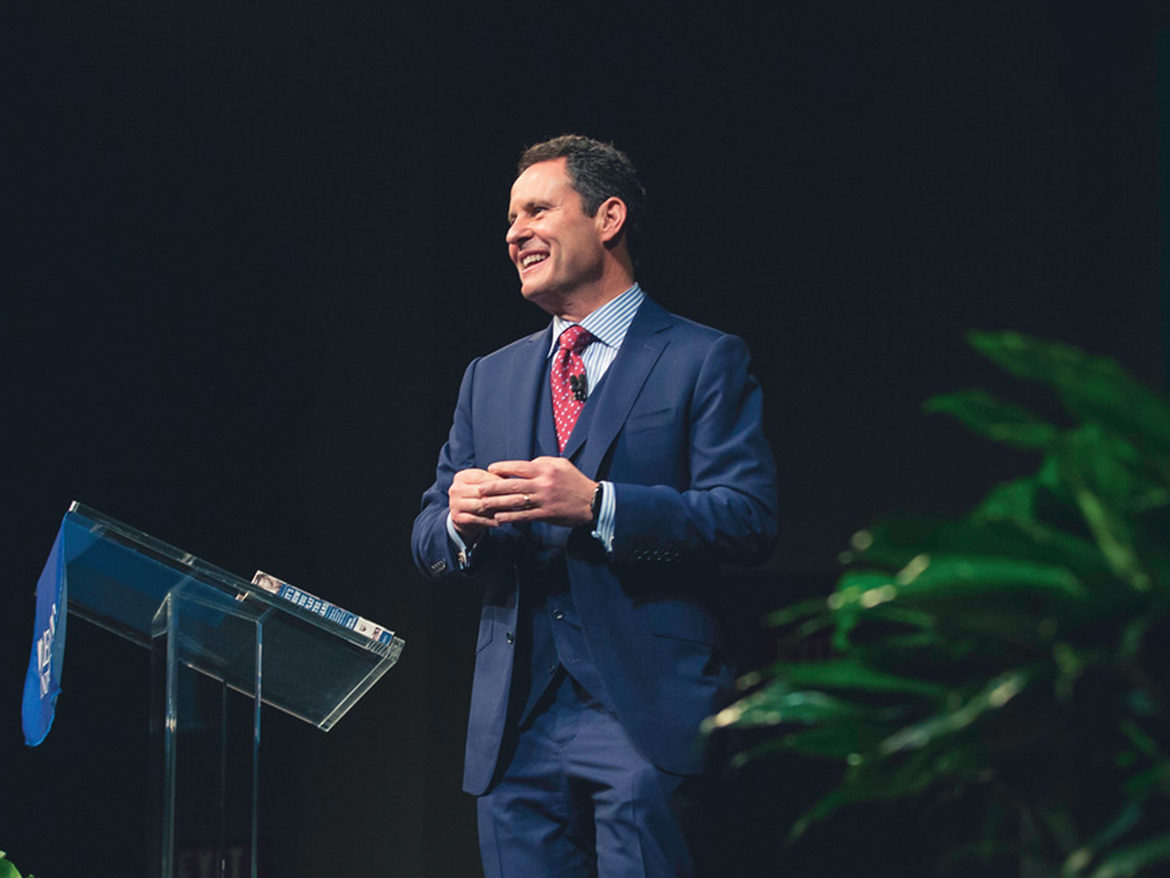 Brian Kilmeade on stage giving a presentation