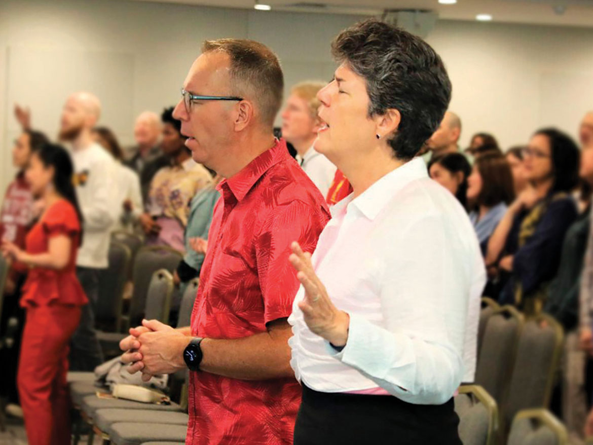 A photo of Jacob and Linda Bloemberg worship God at a church service: Learn more about Regent Giving opportunities.