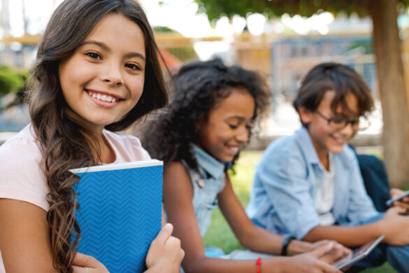 school kids smiling and holding books